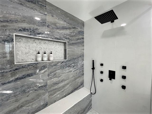 Master Bathroom #1, enjoy the luxury of the marble tiling while standing under the rainfall showerhead while the body jets drift you in to relaxation