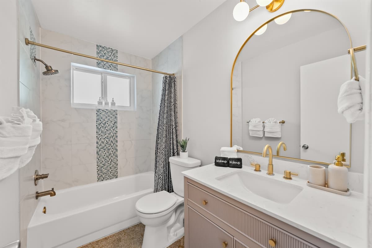 🛁 Start your mornings sparkling in this bright, glam bathroom shared by the hallways bedrooms.