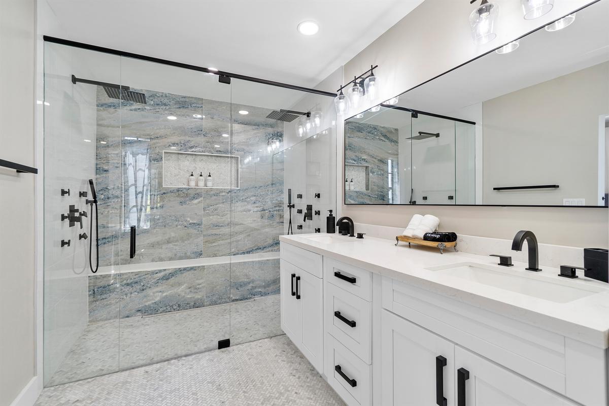 Master Bathroom #1 has dual rain showers fitted with marble tiling & 12 body jets!